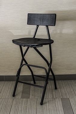 black metal and plastic folding bar chair with back rest and foot rest